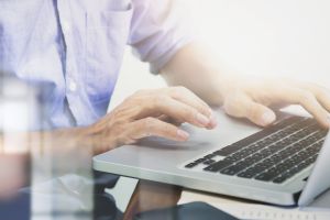 man-s-hands-typing-laptop-keyboard