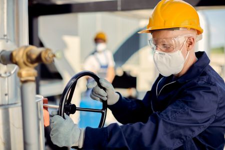 albino-worker-with-face-mask-tightening-valve-construction-site(1)